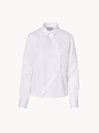 Oversized menswear-inspired white shirt with asymmetric details and structured design